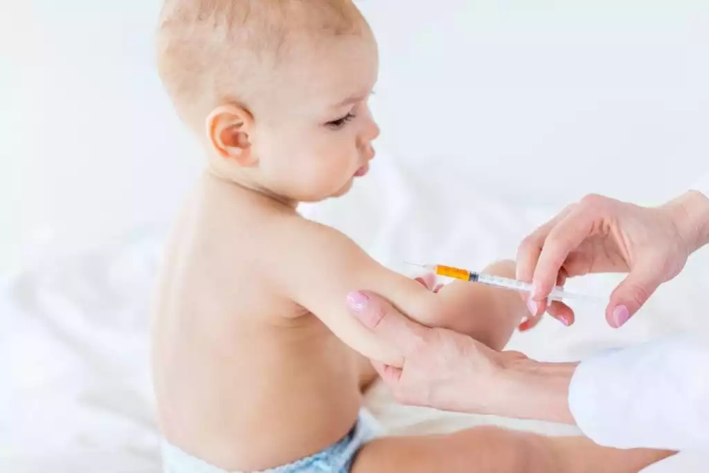 Child receiving a typhoid conjugate vaccine at an immunisation centre