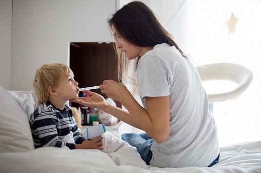 Digital thermometer used to check a child temperature at home